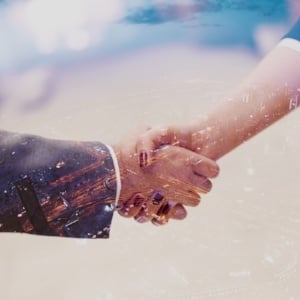 Double exposure design. Business partners concept with businessman and businesswoman handshake at modern office indoors-812458-edited.jpeg